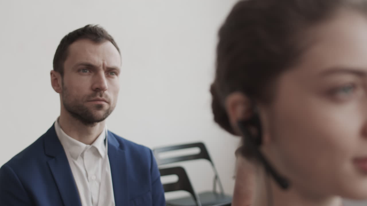 Businessman Sitting Behind Female Manager