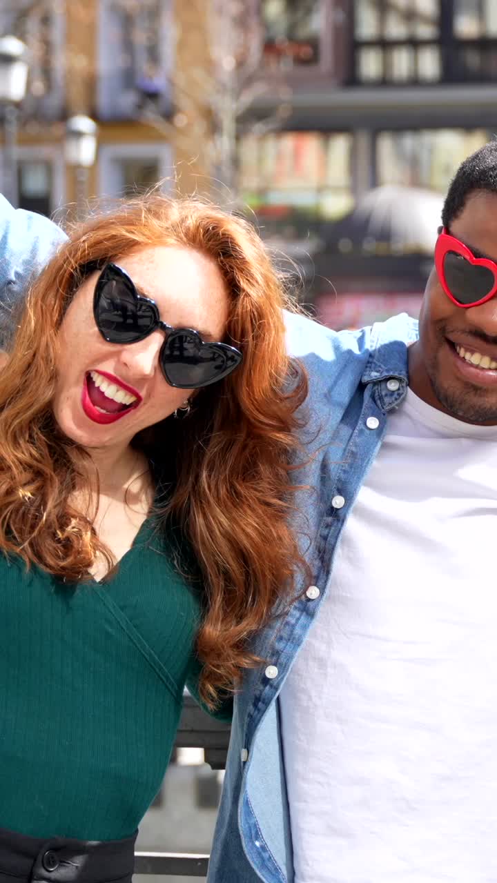 People wearing heart-shaped sunglasses having fun on the street