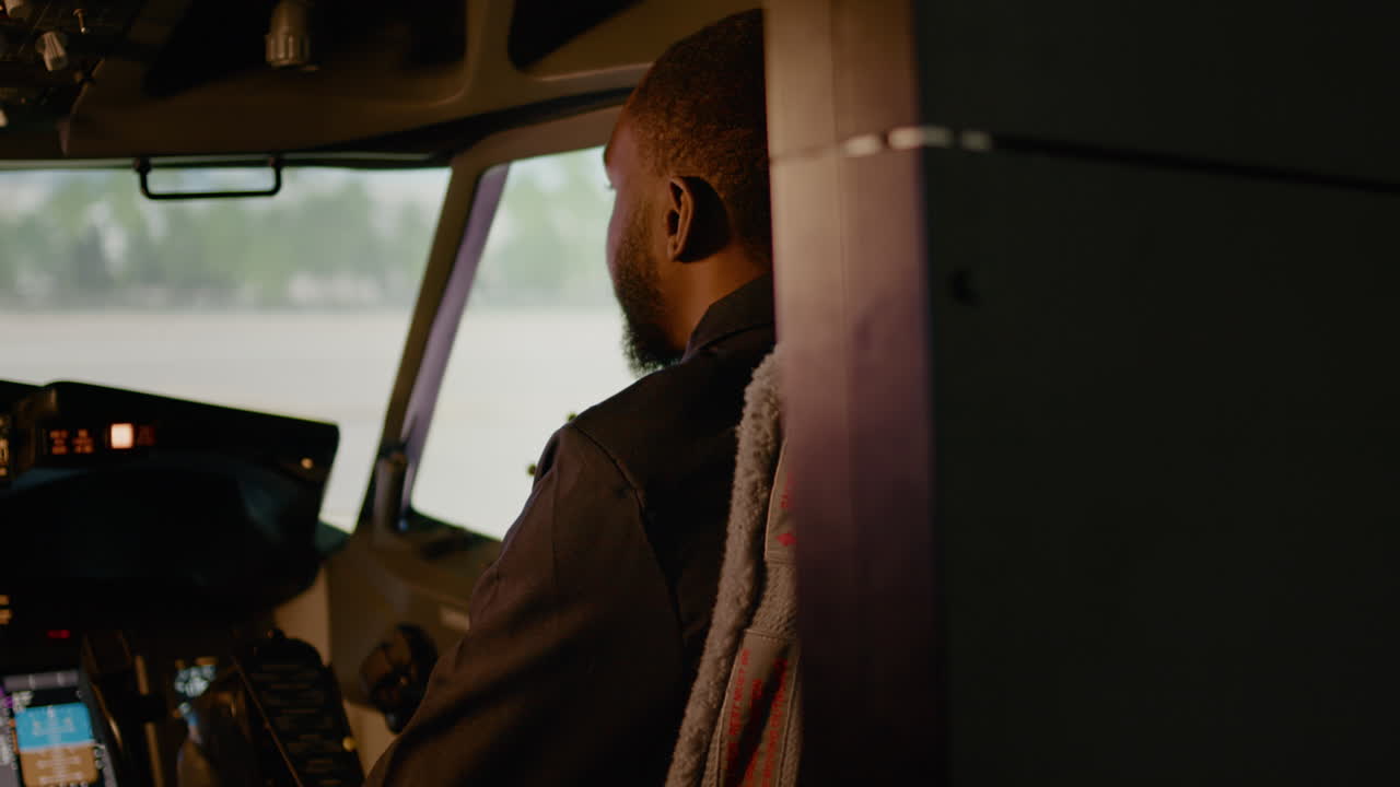 Portrait of african american copilot sitting in airplane cockpit