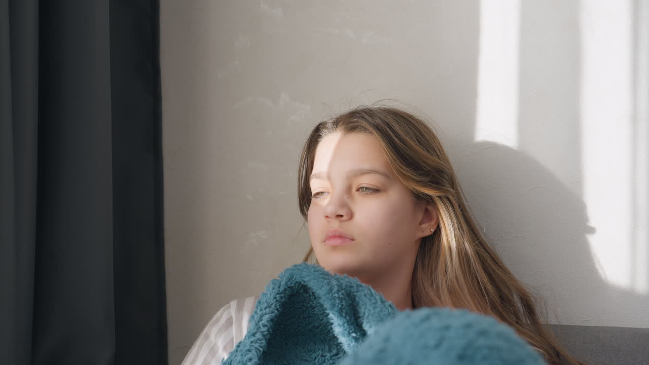 Calm Dreamy Nap, Relaxed Girl Resting Peacefully, Teenager Lying Comfortably Under Soft Blue Cover, Serene Teenage Girl Reclining Peacefully Beneath Blue Cloth With Sunlight Casting Shadows