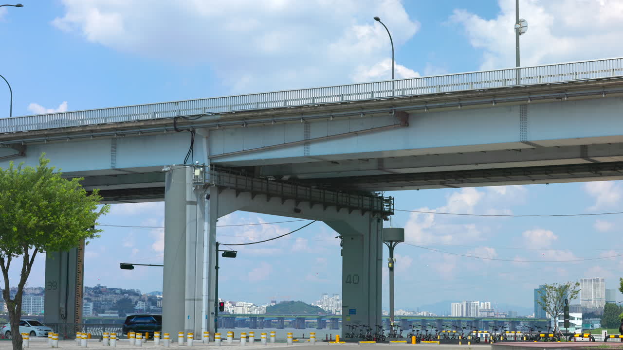 Cityscape near a bridge with clouds in the blue sky