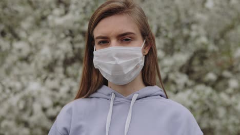 woman wearing face mask in spring flowers