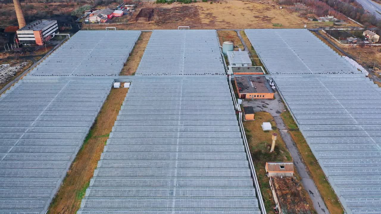 Large glass greenhouses with utilities and heating systems. Agriculture all year round. View from above. Aerial View