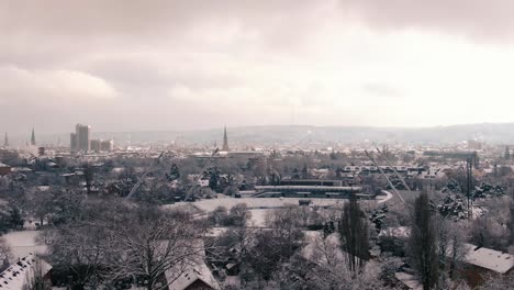 mysterious city covered in snow, european city covered with snow. industrial city covered with snow aerial shot. winter city