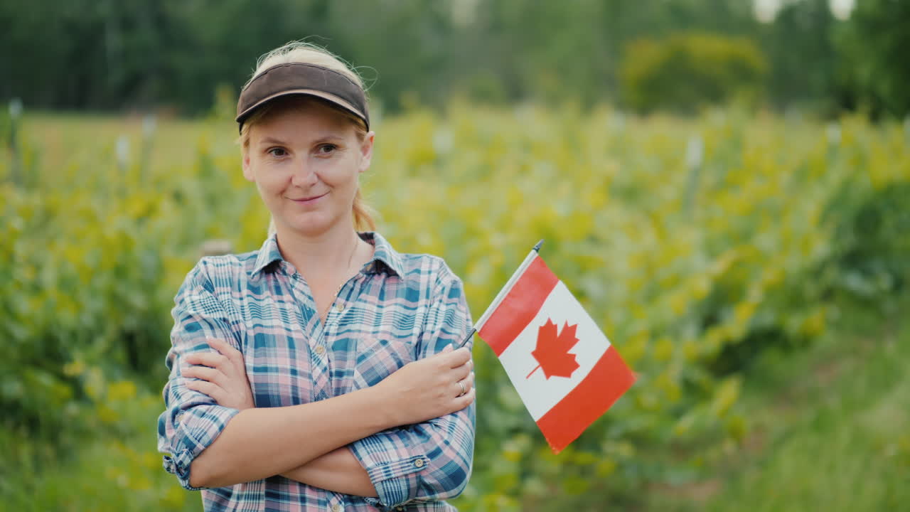 Woman Farmer With Canadian Flag Looking At The Camera Portrait Of An Canadian Farmer