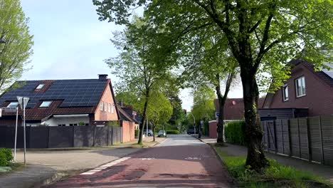 POV-on-street-of-german-small-town-with-modern-solar-panels-on-homes-in-spring-season