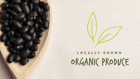 animation of organic produce text in green over fresh organic black beans in wooden bowl