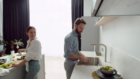 pareja riéndose preparando el almuerzo juntos en una cocina moderna