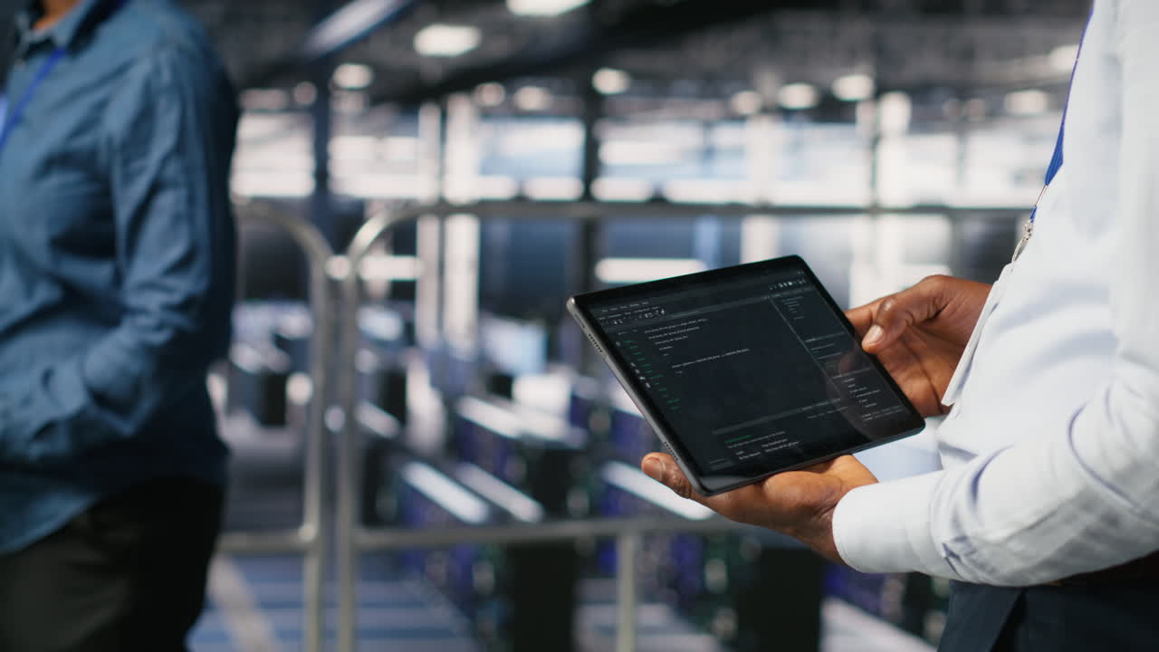 Close up of data center admin using tablet to reviewing machine learning code