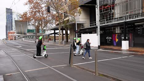 people riding scooters and walking in melbourne