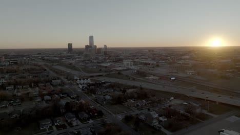 oklahoma city, oklahoma skyline with drone video moving in wide shot at sunset