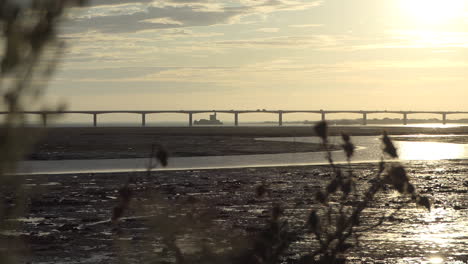 car traffic, bridge to the island d'oleron at sunrise from mainland, fort louvois behind, nouvelle aquitaine, france