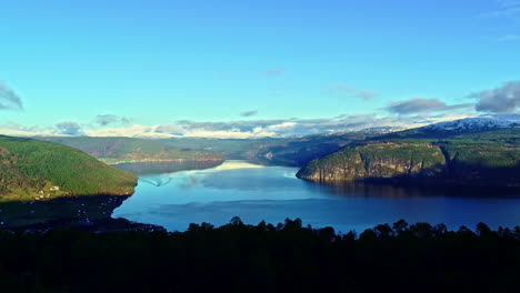 attersee lake in austria with a village along the shore - flying through the trees