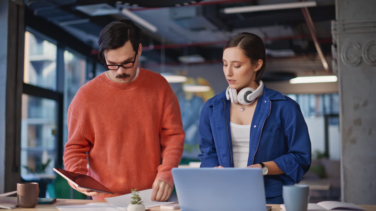 Two managers looking solutions for hard business task at coworking office