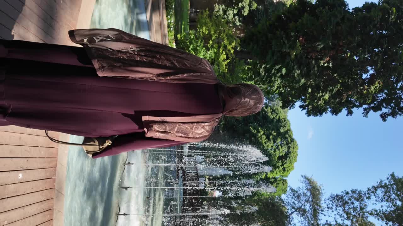 Woman in a Park with a Fountain