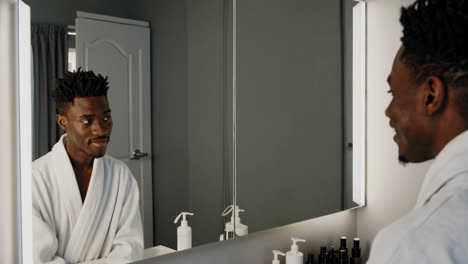 man washing his face in bathroom