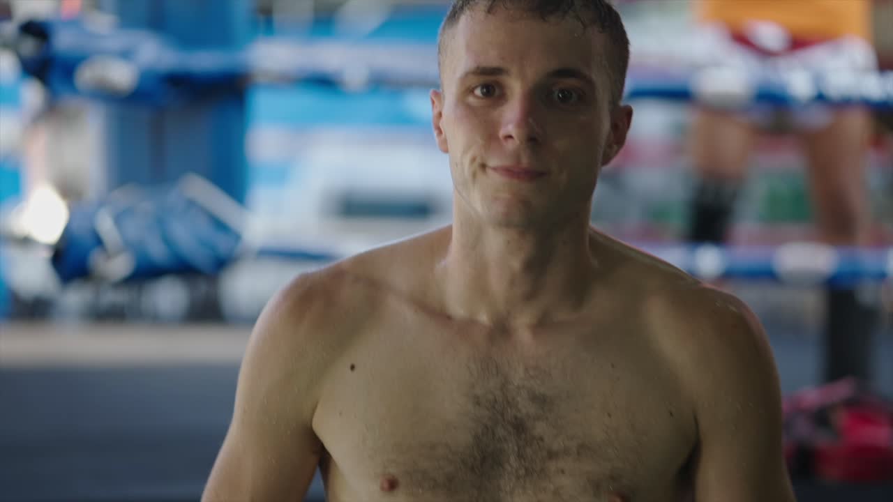 Muay Thai fighter preparing hand wraps in a boxing ring
