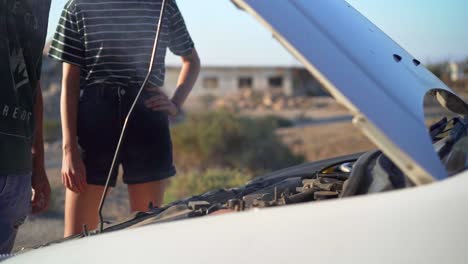 couple stranded with overheated car in the desert