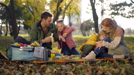 family picnic in the park during autumn