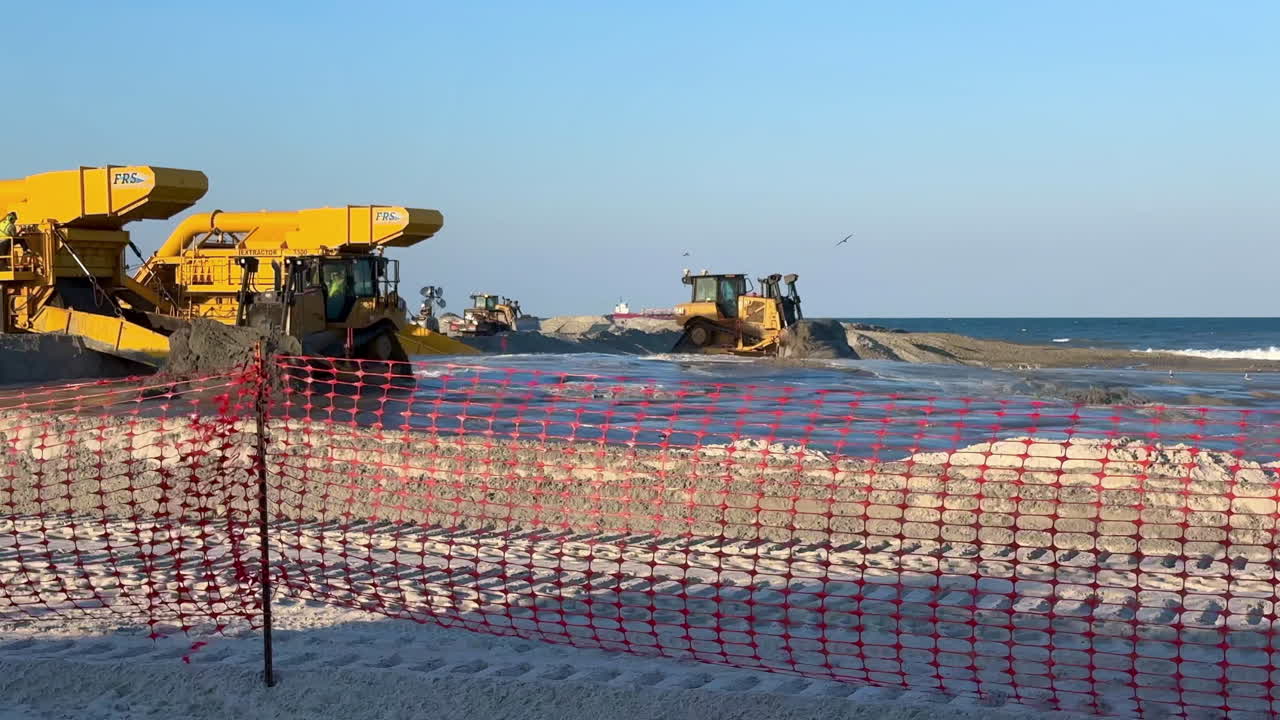 View from behind construction zone fencing, beach sand replenishment