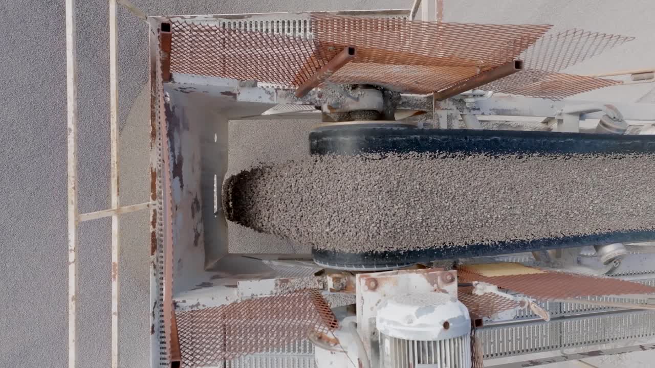 Close up footage of small pebbles falling off of a conveyor belt into a large pile in a quarry in Chattanooga, TN.