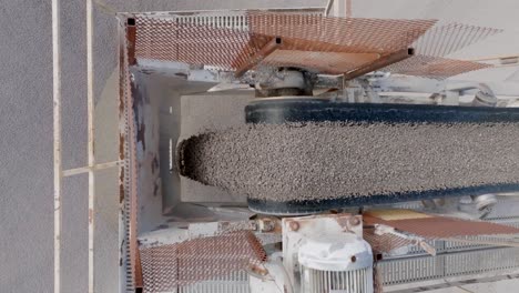 close up footage of small pebbles falling off of a conveyor belt into a large pile in a quarry in chattanooga, tn.