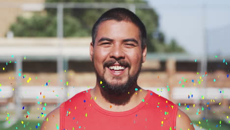 colorful confetti falling against portrait of male soccer player smiling