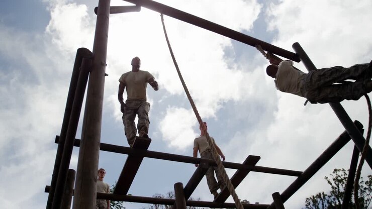 Military troops climbing rope during obstacle course 4k