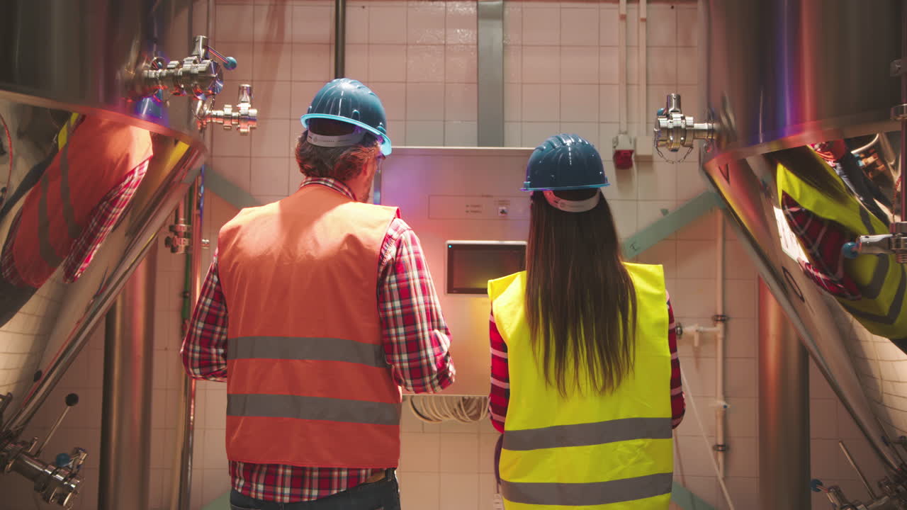 Brewery Workers Inspecting Equipment