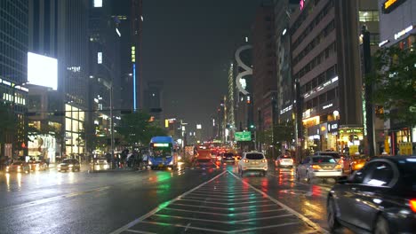 busy wet road in seoul at night