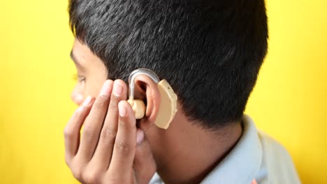 hearing aid concept, teenage boy with hearing problems,