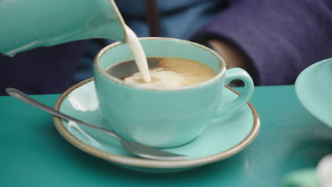 Pouring-milk-into-a-hot-coffee-drink