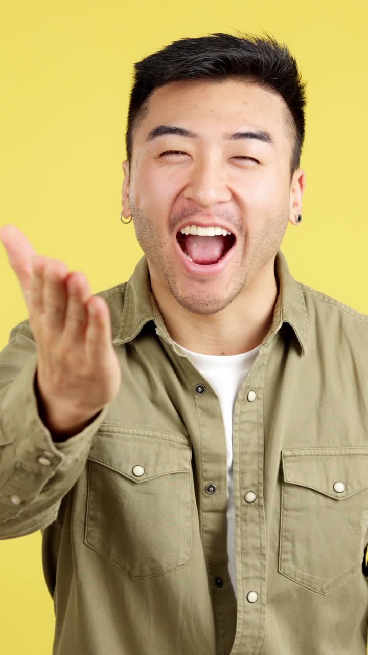 Man making heart shape with hands and blowing kiss