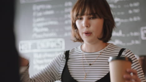 happy barista woman serving customer making payment using smart watch buying coffee spending money in cafe