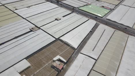 Aerial-view-of-many-greenhouses-and-a-highway-in-the-middle-in-the-south-of-Spain