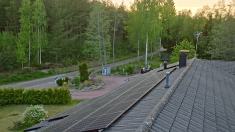 aerial: sunlight generator modules on a ecologic house roof, summer morning