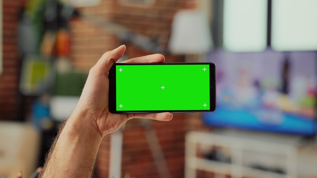 Young manager holding telephone with horizontal greenscreen template