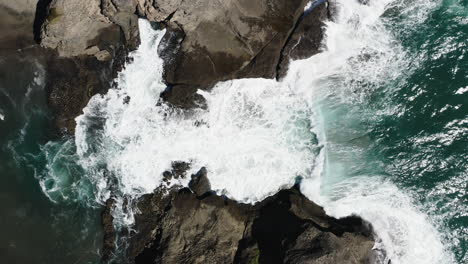 Slow-motion-of-a-wave-flowing-into-narrow-cove-and-breaking-against-the-rocks