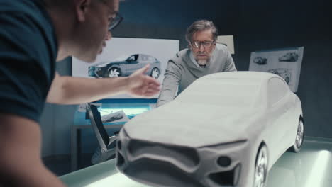 Car Design Team Reviewing a Clay Model Prototype