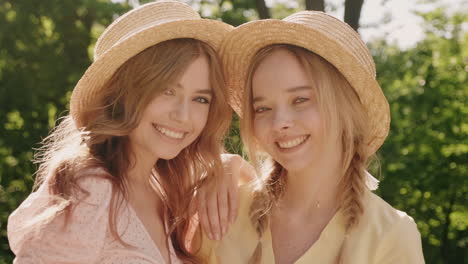 two happy friends posing outdoors in a park