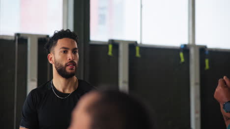 personal trainer leading a group fitness class at the gym