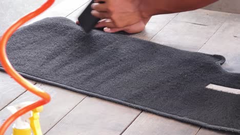 vacuuming car floor mats