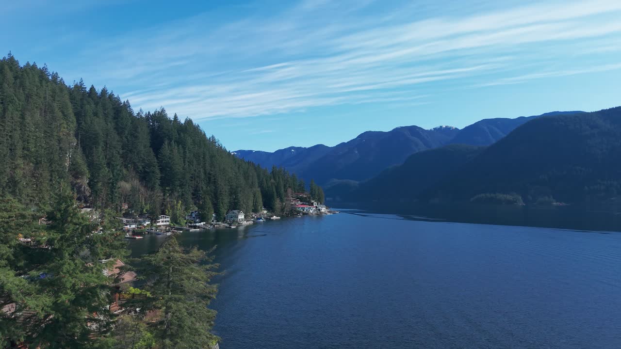 a scenic drone shot of luxury homes with private docks along the riverside in North Vancouver