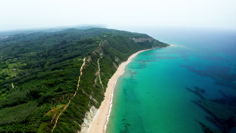 Aerial-drone-shot-over-the-long-stretching-empty-sandy-beach-in-Corfu-in-Greece