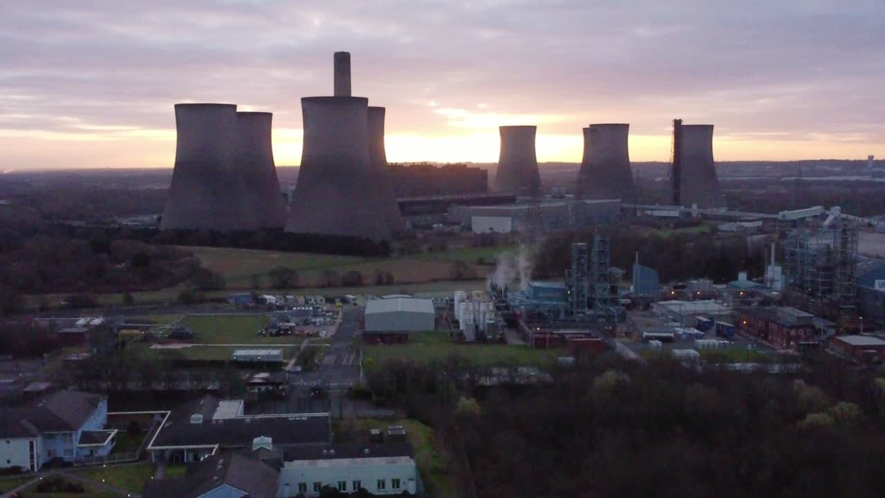 Fiddlers Ferry disused coal fired power station at sunrise, Aerial view wide rising shot