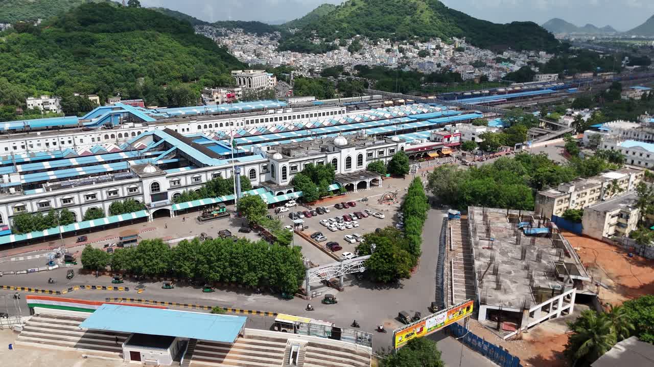 Aerial View of a Busy Train Station in a Hilly City