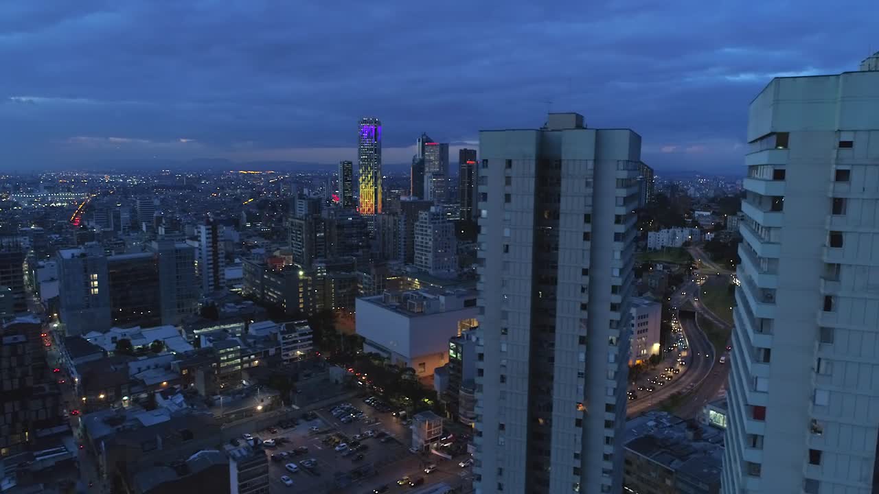 Drone shot over Bogota city center at dusk