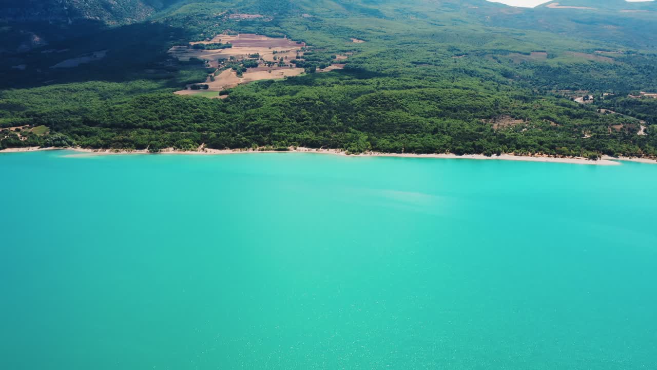 Dramatic clear blue water against healthy green natural backdrop in Gorges du Verdon