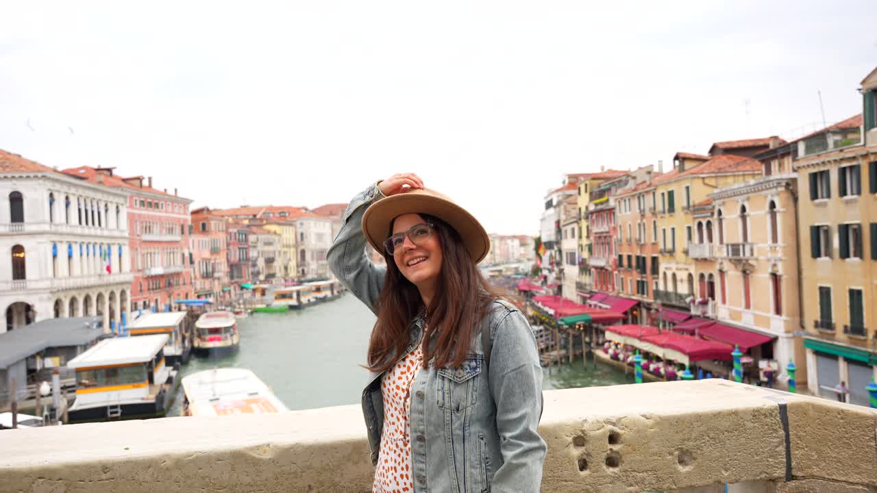 Happy woman tourist enjoying the view from Rialto Bridge, Venice