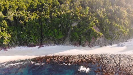 Stunning-Coastal-Landscape-Of-The-West-Coast-At-Monro-Beach-In-New-Zealand-On-A-Sunny-Afternoon---descending-drone-shot